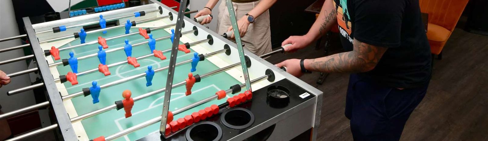 Jugadores disfrutando de una partida de futbolín